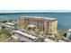 Aerial view of multi-story condominium complex with parking and ocean view at 9 Haig Pl # 310, Dunedin, FL 34698