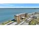 Aerial view showcasing the condo building with nearby beach access and water views at 9 Haig Pl # 310, Dunedin, FL 34698