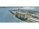 Aerial shot capturing waterfront condos, covered parking, and lush greenery against the ocean at 9 Haig Pl # 310, Dunedin, FL 34698