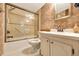 Bathroom featuring a vanity, a toilet and a bathtub with sliding doors at 9 Haig Pl # 310, Dunedin, FL 34698
