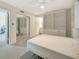 Bright bedroom includes a murphy bed, white shelves, and a mirrored closet at 9 Haig Pl # 310, Dunedin, FL 34698
