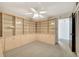 Bedroom with a ceiling fan, carpeted floor, and cabinets at 9 Haig Pl # 310, Dunedin, FL 34698