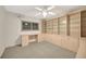 Bright bedroom with built-in cabinets, desk, and ceiling fan at 9 Haig Pl # 310, Dunedin, FL 34698