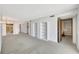 Spacious living area features neutral carpet, built-in shelves, and ample natural light at 9 Haig Pl # 310, Dunedin, FL 34698