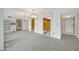 Bright living room featuring neutral carpeting, chandelier and decorative wooden doors at 9 Haig Pl # 310, Dunedin, FL 34698