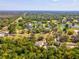 Scenic aerial view of a home with lush landscaping, golf course, and a tranquil community setting at 920 E Lake Dr, Tarpon Springs, FL 34688