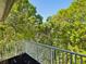 Charming balcony view overlooks wooded grounds at 920 E Lake Dr, Tarpon Springs, FL 34688