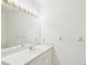 Well-lit bathroom showcasing a large mirror, vanity with storage, and a clean, minimalist design at 920 E Lake Dr, Tarpon Springs, FL 34688