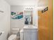 Neutral half bathroom featuring a single sink vanity and toilet at 920 E Lake Dr, Tarpon Springs, FL 34688