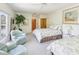 Bedroom with large windows, and tree top views at 920 E Lake Dr, Tarpon Springs, FL 34688