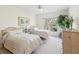 Inviting bedroom featuring two twin beds, a ceiling fan, and a large window for natural light at 920 E Lake Dr, Tarpon Springs, FL 34688
