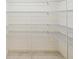Spacious walk-in closet features custom shelving, optimizing storage and organization for clothing and accessories at 920 E Lake Dr, Tarpon Springs, FL 34688