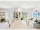 Bright dining area with a large table and view of tropical foliage at 920 E Lake Dr, Tarpon Springs, FL 34688