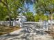 Gated entrance with white fence leading to the property, providing privacy and security at 920 E Lake Dr, Tarpon Springs, FL 34688
