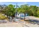 Gated entrance with white fence leading to a two-door garage, ensuring privacy and security at 920 E Lake Dr, Tarpon Springs, FL 34688