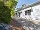 Side exterior showing a partial view of the home, a driveway and tree shadows at 920 E Lake Dr, Tarpon Springs, FL 34688