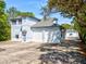 Exterior view of home featuring a large driveway and multi-car garages at 920 E Lake Dr, Tarpon Springs, FL 34688
