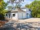 Spacious home featuring a multi-car garage, dormer windows, and a large paved driveway at 920 E Lake Dr, Tarpon Springs, FL 34688