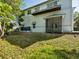 Back exterior showing a screened-in porch and a second story balcony at 920 E Lake Dr, Tarpon Springs, FL 34688