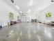 Spacious garage interior with a concrete floor and a variety of tools and equipment at 920 E Lake Dr, Tarpon Springs, FL 34688