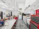 Garage interior featuring tool bench, equipment, cabinets, and a car lift at 920 E Lake Dr, Tarpon Springs, FL 34688