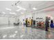 Spacious garage featuring epoxy floors, lift, and plenty of room for vehicle maintenance and storage at 920 E Lake Dr, Tarpon Springs, FL 34688