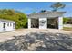 Wide angle showing the side of the garage and storage shed with double bay doors at 920 E Lake Dr, Tarpon Springs, FL 34688