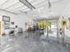 Spacious garage interior with a polished concrete floor, ample lighting, and work areas at 920 E Lake Dr, Tarpon Springs, FL 34688
