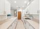 Bright, galley kitchen featuring ample counter space, white cabinets, and modern appliances for efficient cooking at 920 E Lake Dr, Tarpon Springs, FL 34688