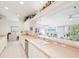 Open kitchen with cabinets, counter space and view to dining area with outdoor views at 920 E Lake Dr, Tarpon Springs, FL 34688