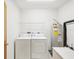 Practical laundry room featuring washer, dryer, and water heater at 920 E Lake Dr, Tarpon Springs, FL 34688