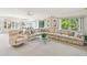 Open-concept living room boasts natural light, spacious seating, and serene views for relaxed living and entertaining at 920 E Lake Dr, Tarpon Springs, FL 34688
