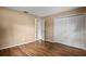 Bedroom featuring wood floors, closet and attached bathroom at 9287 Horizon Dr, Spring Hill, FL 34608