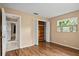 Bedroom with wood floors, natural light from the window at 9287 Horizon Dr, Spring Hill, FL 34608