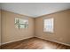 Bedroom with wood floors, natural light from two windows at 9287 Horizon Dr, Spring Hill, FL 34608