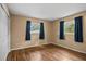 Cozy bedroom with wood floors, natural light from two windows at 9287 Horizon Dr, Spring Hill, FL 34608