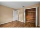 Bedroom featuring wood floors, closet, and attached bathroom at 9287 Horizon Dr, Spring Hill, FL 34608