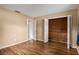 Bedroom featuring wood floors, closet, and attached bathroom at 9287 Horizon Dr, Spring Hill, FL 34608