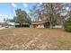 Exterior view of home with mature trees and landscaping at 9287 Horizon Dr, Spring Hill, FL 34608