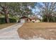Single-story home featuring stone accents and an attached garage with a spacious front yard at 9287 Horizon Dr, Spring Hill, FL 34608