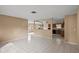 Open floor plan with tiled floors and view into kitchen area at 9287 Horizon Dr, Spring Hill, FL 34608