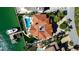 Aerial view of waterfront property with a private dock, pool, and lush landscaping at 940 Monte Cristo Blvd, Tierra Verde, FL 33715