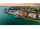 Panoramic view of waterfront homes, manicured lawns, docks, and boat lifts in a vibrant community at 940 Monte Cristo Blvd, Tierra Verde, FL 33715