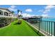 Beautiful backyard with synthetic grass, waterfront views, and dock perfect for entertaining and relaxation at 940 Monte Cristo Blvd, Tierra Verde, FL 33715