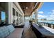 Spacious outdoor balcony with comfortable seating, a dining table, and waterfront views at 940 Monte Cristo Blvd, Tierra Verde, FL 33715