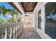 Balcony with stone flooring, white pillars, and views of palm trees and the neighborhood at 940 Monte Cristo Blvd, Tierra Verde, FL 33715