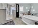 Modern bathroom featuring a standalone tub, walk-in shower, and stylish fixtures at 940 Monte Cristo Blvd, Tierra Verde, FL 33715