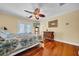 Cozy bedroom with hardwood floors and a ceiling fan at 940 Monte Cristo Blvd, Tierra Verde, FL 33715