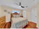 Cozy bedroom with ceiling fan, wood floors, and bathroom access at 940 Monte Cristo Blvd, Tierra Verde, FL 33715