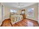 Bright bedroom featuring two windows, ceiling fan, and dresser at 940 Monte Cristo Blvd, Tierra Verde, FL 33715